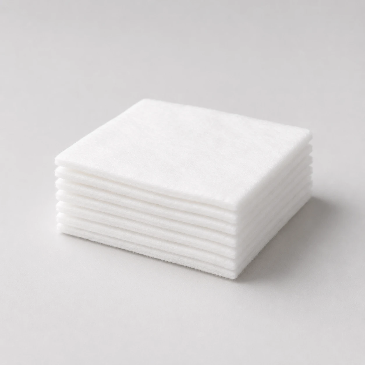 Stack of flat white medical cotton pads
