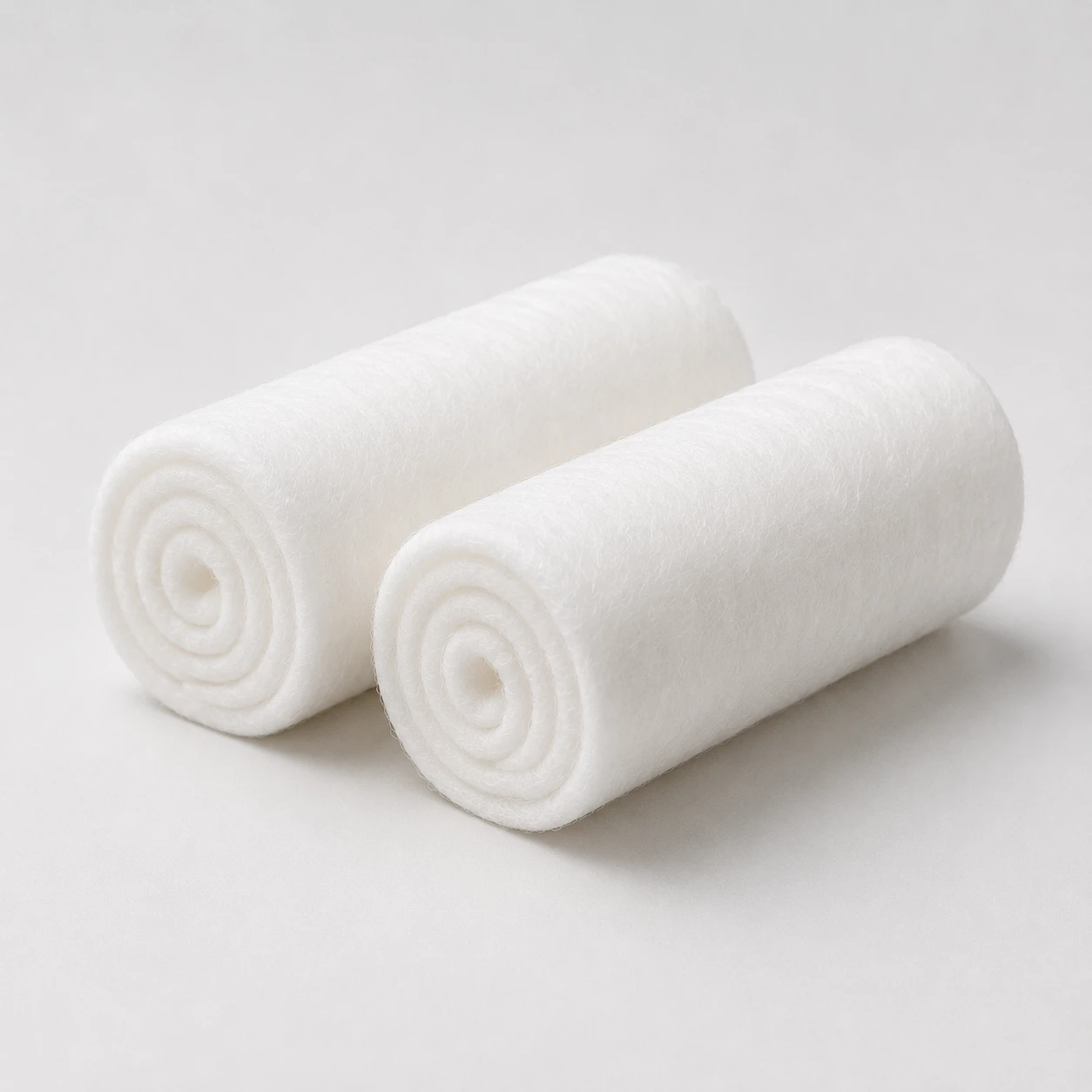Two rolled absorbent cotton rolls